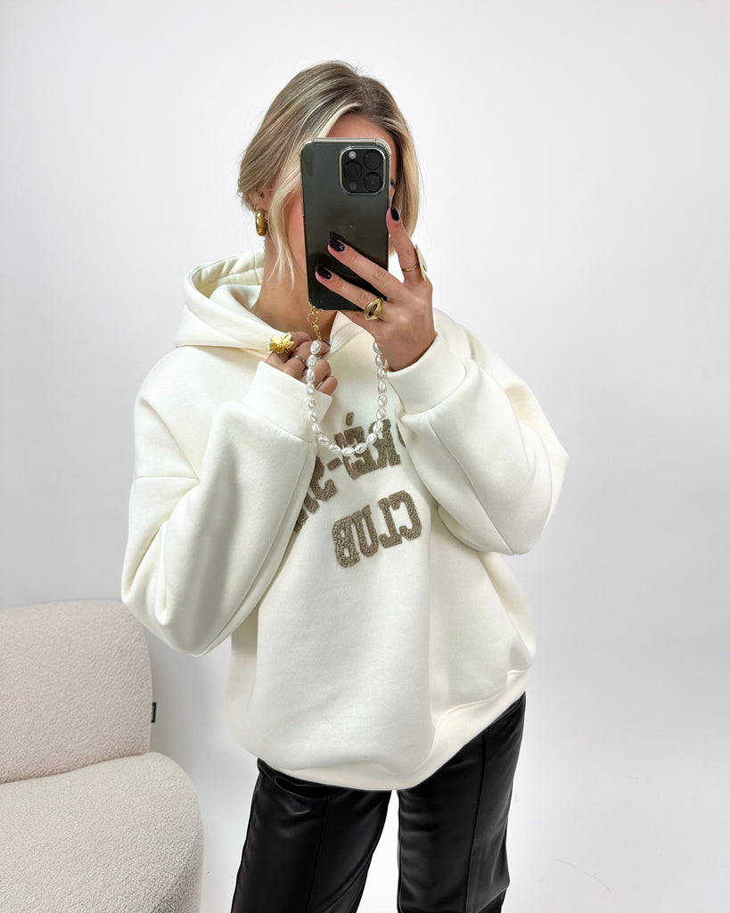 Creme/witte hoodie/trui met bruine teddy tekst erop: Apres-Ski Club