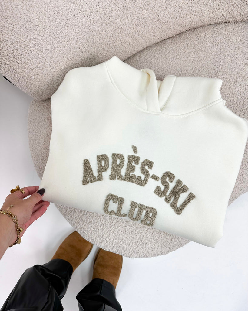 Creme/witte hoodie/trui met bruine teddy tekst erop: Apres-Ski Club